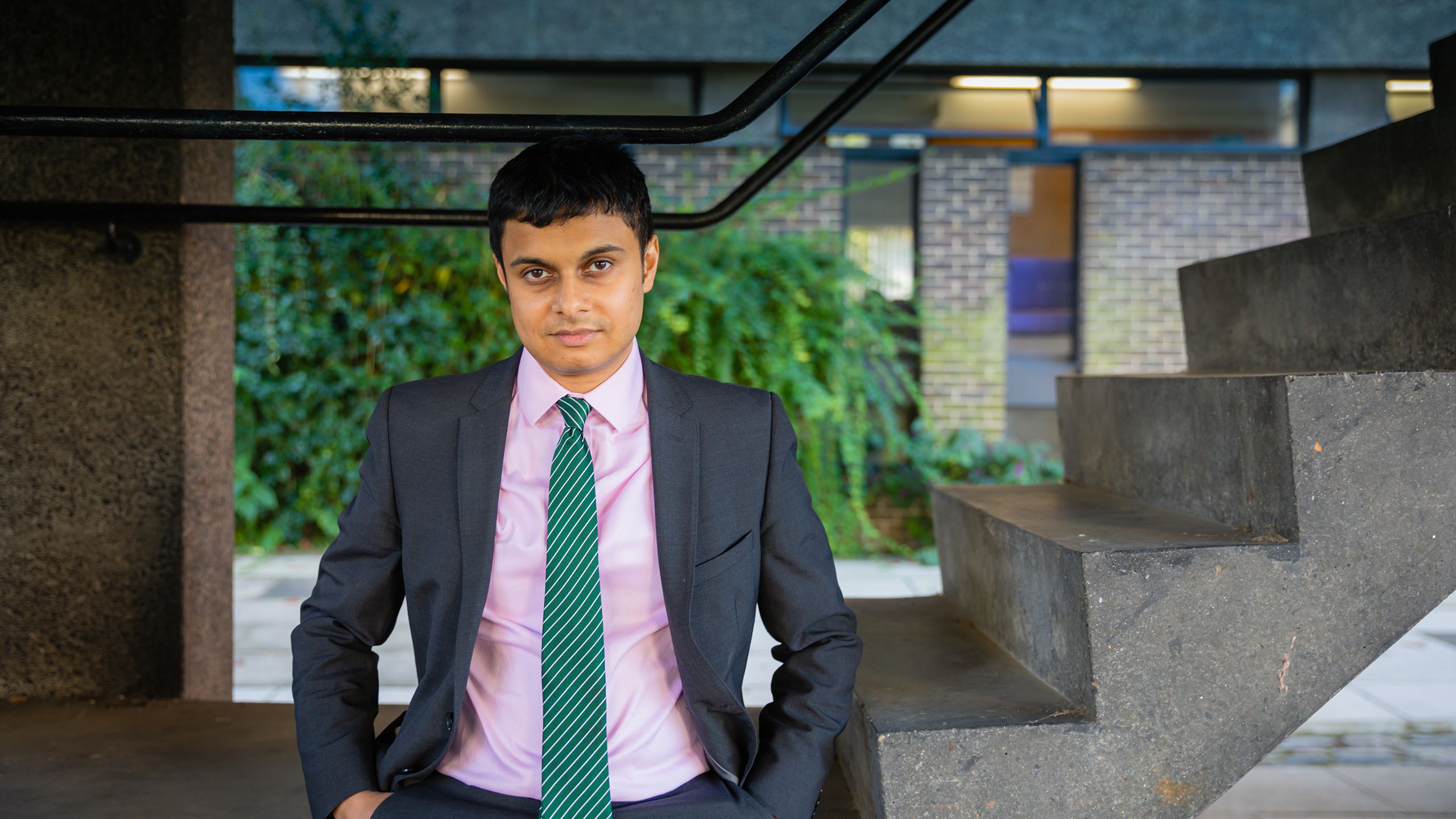 Nikhil Krishnan at Sidgwick Site, sitting on steps 