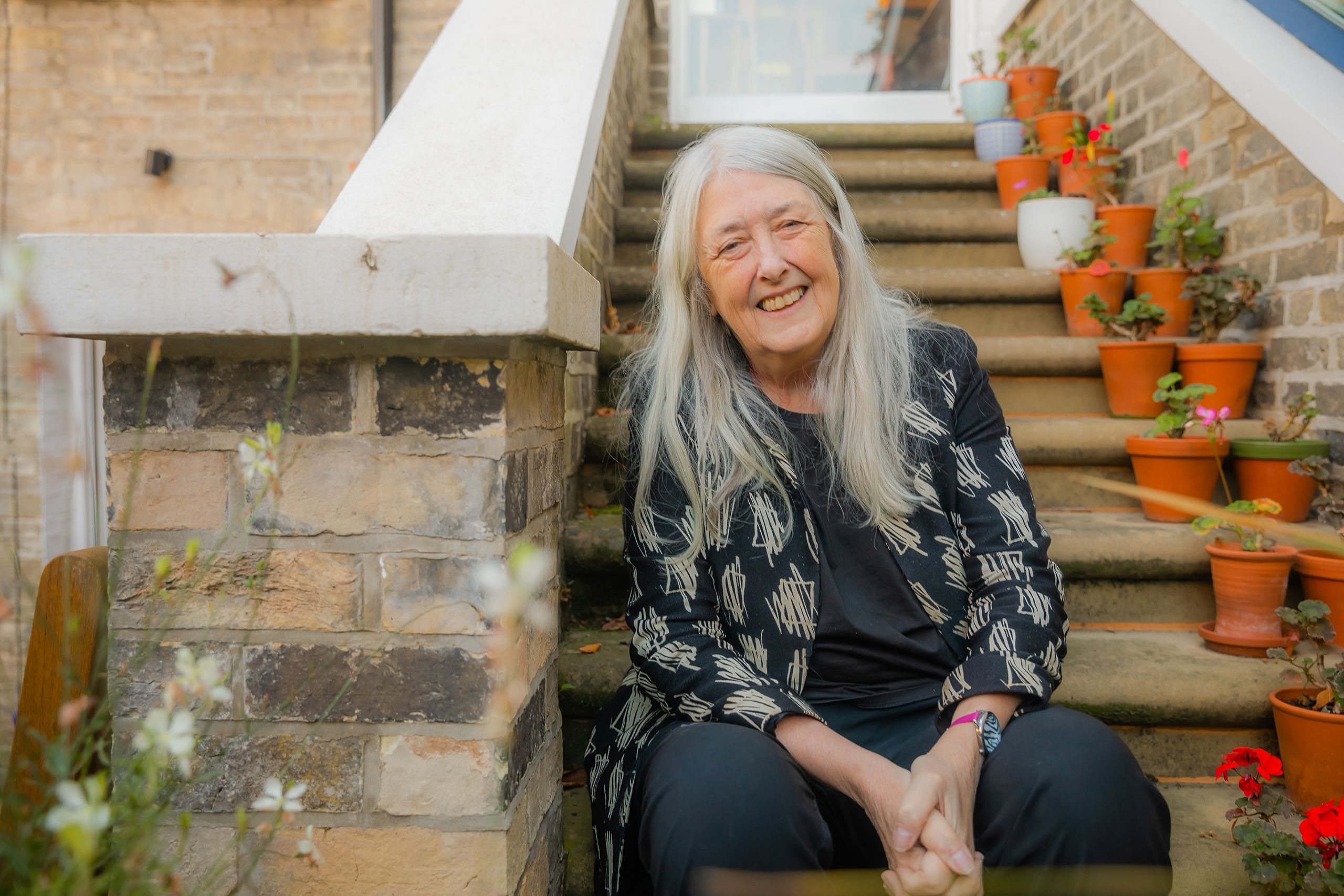 Mary Beard sitting on steps