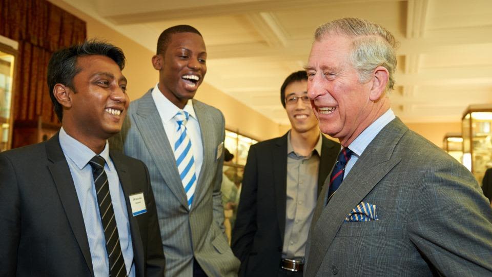 King Charles III laughing with students at Cambridge University