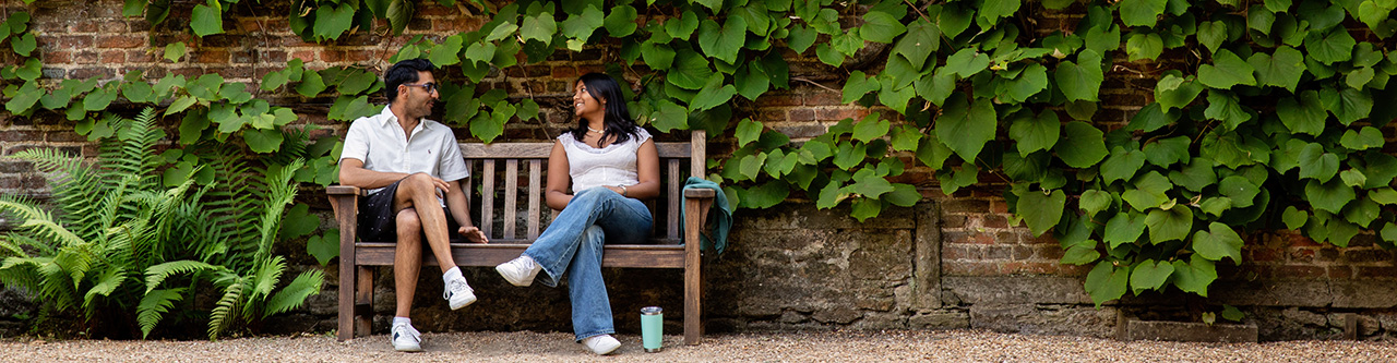 Students sitting in College ground in conversation.