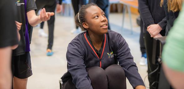 Student using an indoor rowing machine