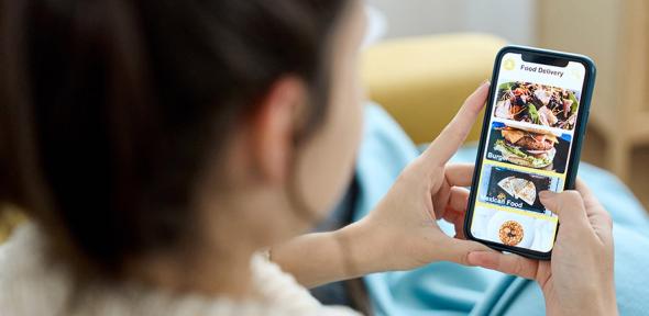 Woman using a food delivery app on her mobile phone