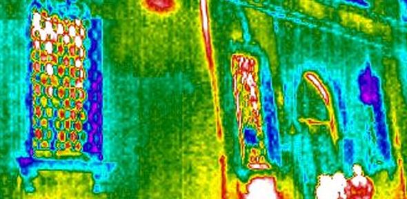 Thermal image of two people standing outside a building. The study found that in many European countries, including the UK, predicted energy usage in homes bears little resemblance to the amount used in practice.