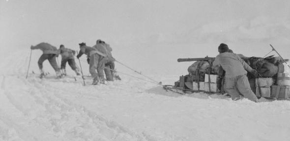 Foundering in soft snow: Bowers' sledge team; Wilson pushing; Oates and PO Evans repairing, Beardmore Glacier, 13 December 1911