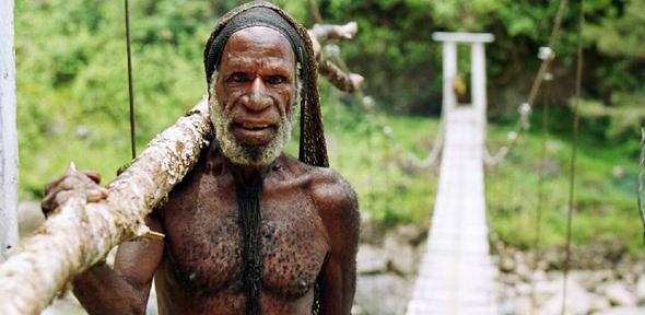 Dani tribesman on his way to his village in the Baliem Valley, Papua. 