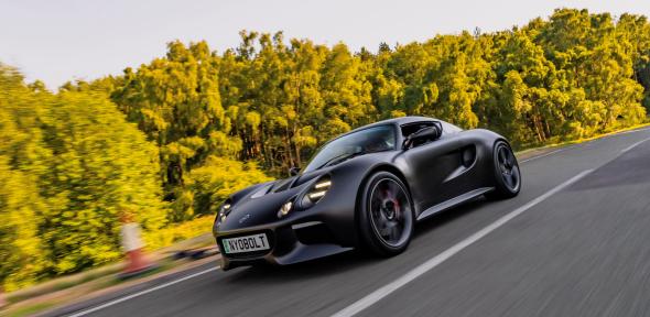 The Nyobolt EV sportscar driving along a road.