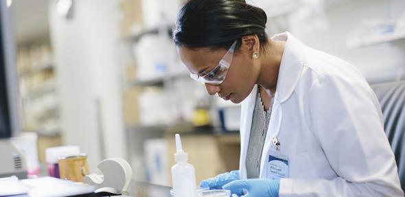 Scientist examining slide.