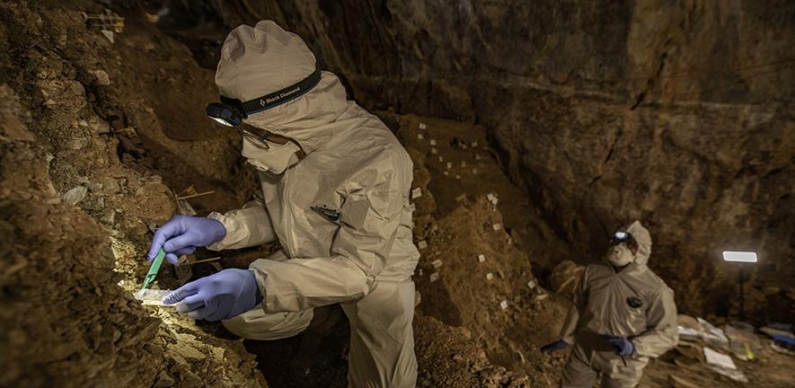 Assistant Professor Mikkel Winther Pedersen with team members sampling the different cultural layers in the cave. 