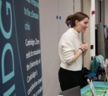 Cambridge stall is staffed by one person at Green Careers Fair talking to students