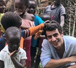 Joao Costa surrounded by children in Guinea-Bissau