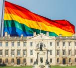 Composite of Gibbs Building at King's College superimposed onto a rainbow flag