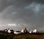 Vehicles with weather observation equipment track a storm