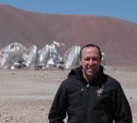 John, in front of the 12-metre-diameter antennas at the ALMA Array Operations Site