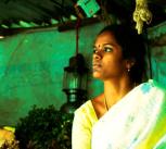 A vegetable vendor uses a solar lamp to light her stall