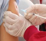 Close up of a person being injected with a vaccine