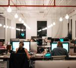 People in office sitting in front of computers