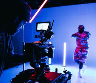 Videographer in studio with a model, photo by Kyle Loftus