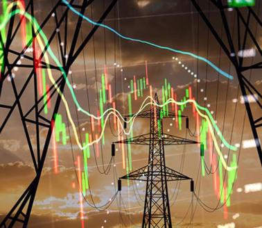 High voltage electricity towers combined with economic charts. Photo by Anton Petrus, Getty images