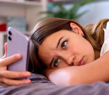 Teenage girl looking at her mobile phone.