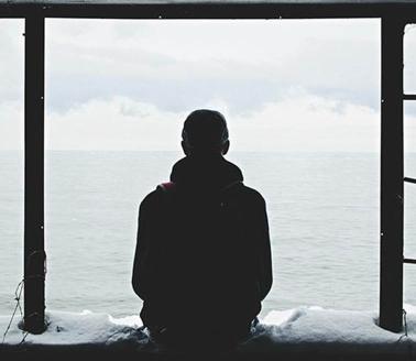 man staring outside all alone, by noah silliman, unsplash