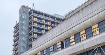 Glassy building credit: Ruben Pinto / iStock / Getty Images Plus via Getty Images https://www.gettyimages.co.uk/detail/photo/front-facade-of-the-hospital-royalty-free-image/641289888?adppopup=true