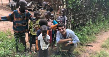 Joao Costa surrounded by children in Guinea-Bissau