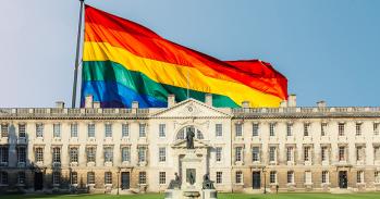 Composite of Gibbs Building at King's College superimposed onto a rainbow flag