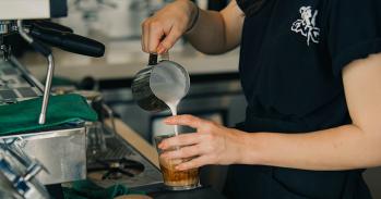 A barista making a coffee