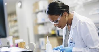 Scientist examining slide.