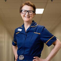 Elaine Chapman standing in front of entrance to oncology ward