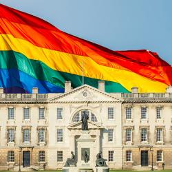 Composite of Gibbs Building at King's College superimposed onto a rainbow flag