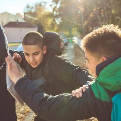 Teenage boys fighting on way to school