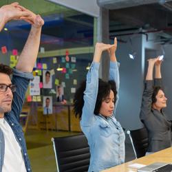 Workers stretching at their desks