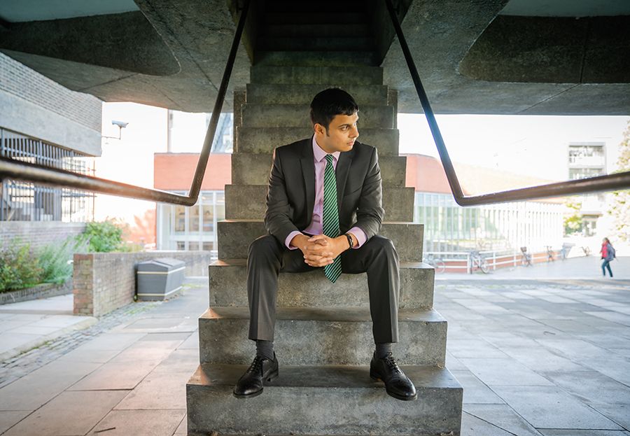 Nikhil Krishnan at Sidgwick Site, sitting on steps 