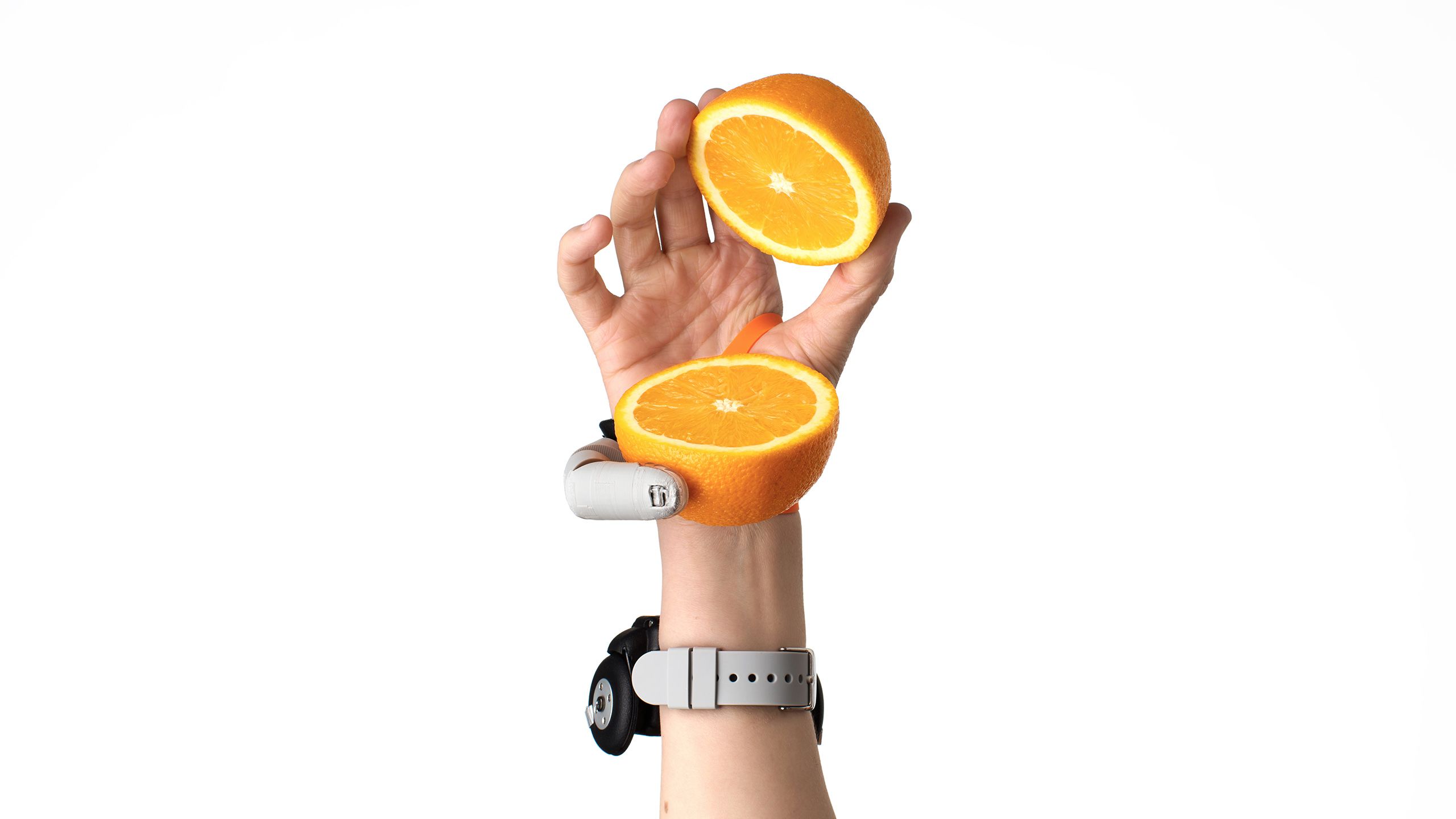 Third Thumb holding a sliced orange