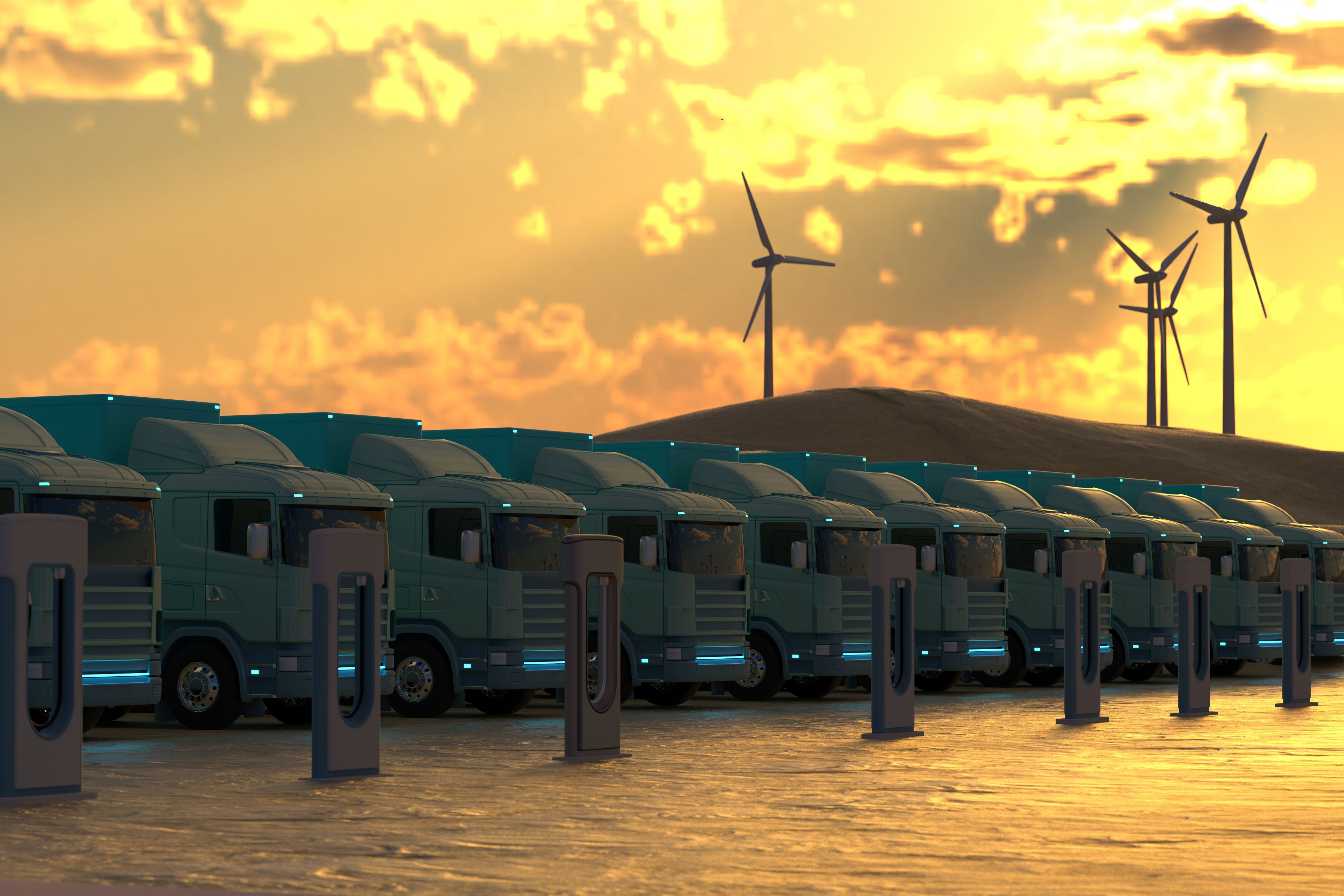 A row of clean energy trucks, wind turbines in the background