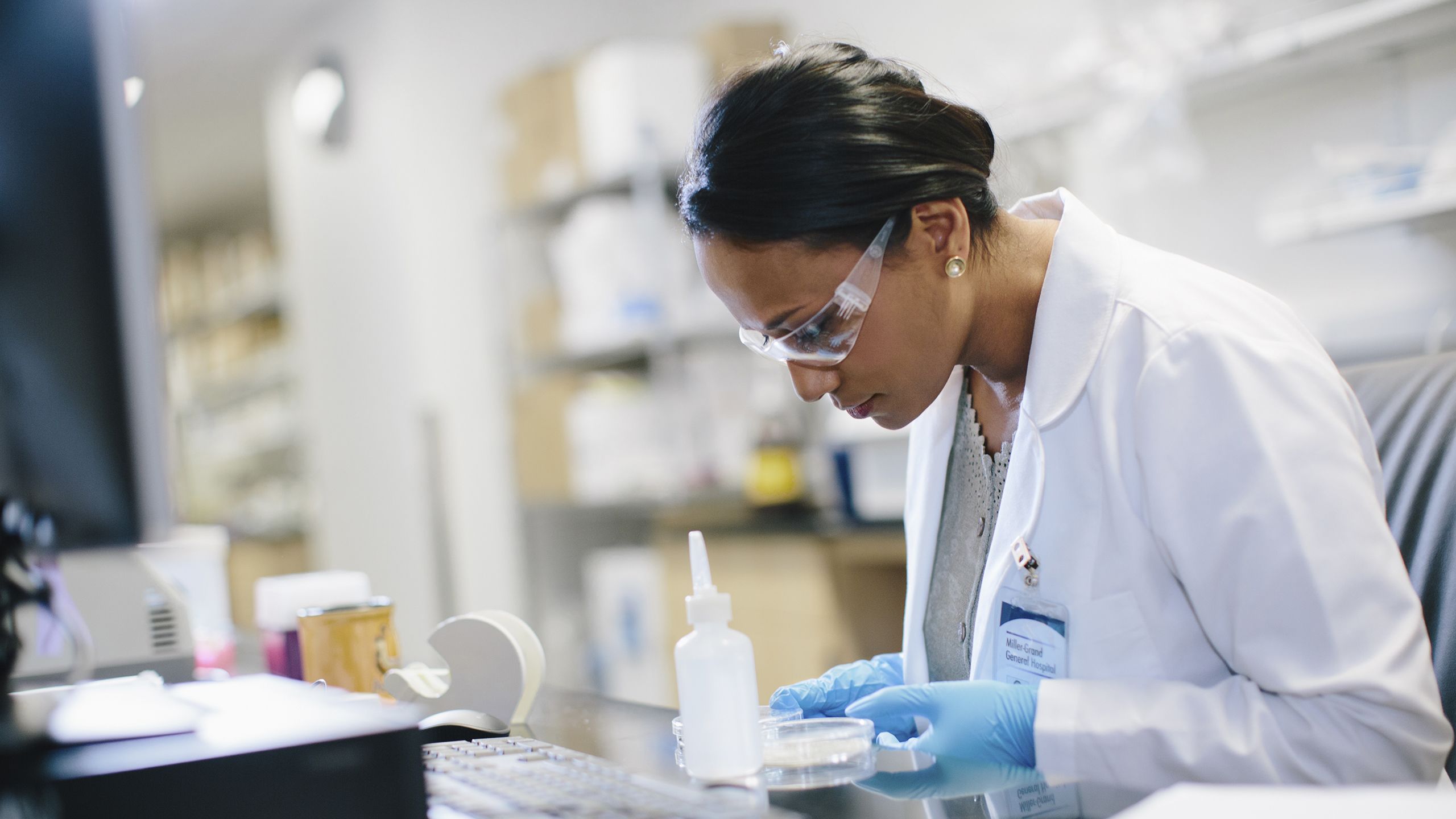 Female doctor looking at petri dish