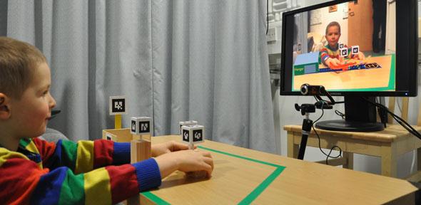 A normally developed child engaged in pretend play with the Augmented Reality system