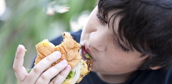 Boy eating a burger