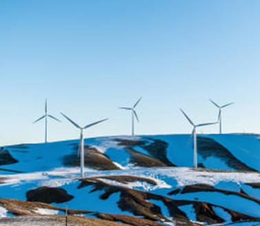 Windmills on hillside.