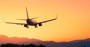 Plane lands at dusk