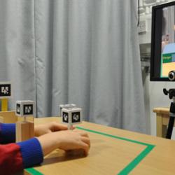 A normally developed child engaged in pretend play with the Augmented Reality system