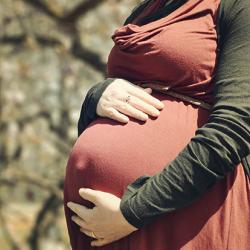 Pregnant woman holding her stomach