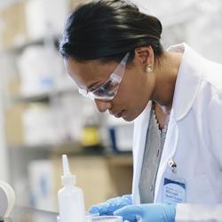 Scientist examining slide.